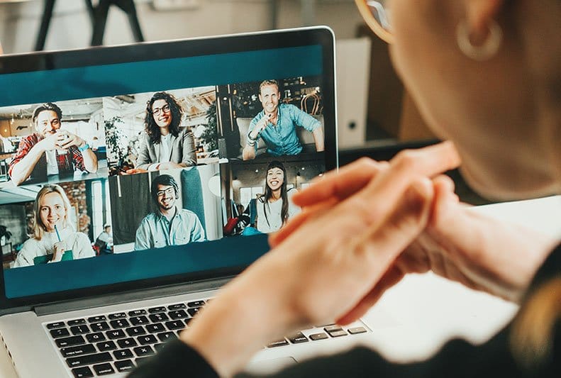 Video remote interpreter signing on laptop in Morristown, NJ